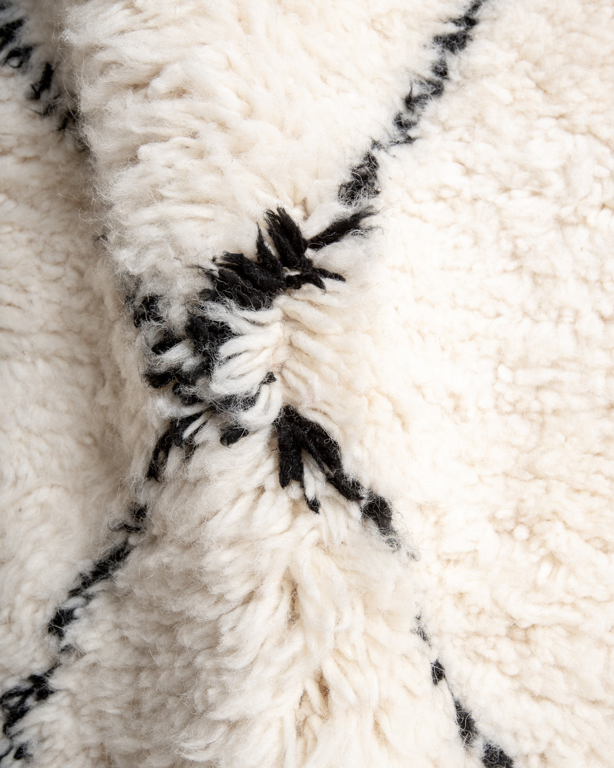 Modern, designer, handcrafted Berber rug from Morocco. Beniourain carpet with minimalist design, natural wool pile and a fluffy texture.